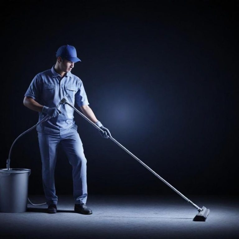 Hausmeister Dienstleistung Reinigungskraft putzt den Boden mit einem Besen und Eimer in dunkler Umgebung.
